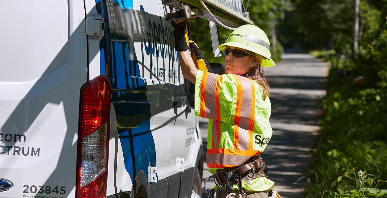 Spectrum technician working on broadband expansion project